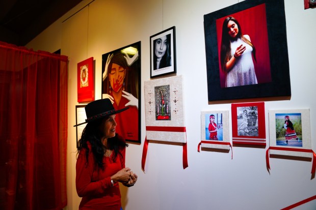 Artist Teyana Viscarra of Chula Vista walks the exhibit of "Walking in Beauty: Life as Ceremony" at the Bonita Museum & Cultural Center on Friday, Nov. 7, 2025, in Bonita, CA.  On display are about 50 "Prayer Runs" she has created representing the missing and murdered Indigenous women.  (Nelvin C. Cepeda / The San Diego Union-Tribune)