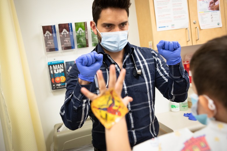 Dr. Andres Gomez examines patient Aiden Correa at San Ysidro Health Center in San Ysidro, Dec. 7, 2021. (File photo courtesy Zoë Meyers/inewsource)