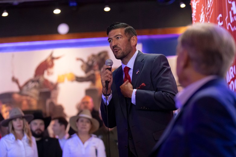 Marc LaHood, a candidate for Texas House of Representatives (R-121) appeals to voters along with Governor Greg Abbott at the Angry Elephant on Wednesday.