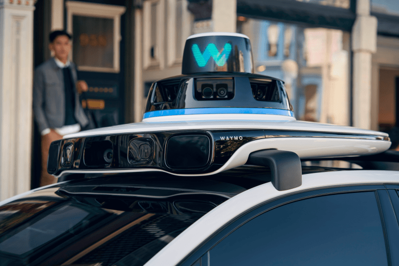 The top of a vehicle displaying a W for Waymo