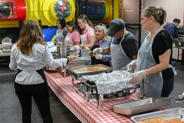 Dozens of volunteers of the Coast Christian Fellowship come together...