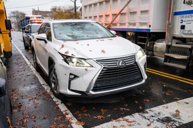 A deliveryman on a bicycle collided with a Lexus at E. 56th St. and Linden Blvd. in East Flatbush, Brooklyn, on Friday, Nov. 21, 2025. (Theodore Parisienne / New York Daily News)