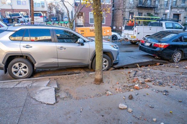 A major water main break broke up the roadway in...
