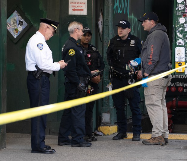 A law enforcement officer holds a suspicious package found to be not a threat at 6th Ave. and 14th St. in Manhattan on Monday, Nov. 3, 2025. (Barry Williams/ New York Daily News)