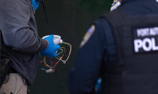 A law enforcement officer holds a suspicious package found to be not a threat at 6th Ave. and 14th St. in Manhattan on Monday, Nov. 3, 2025. (Barry Williams/ New York Daily News)