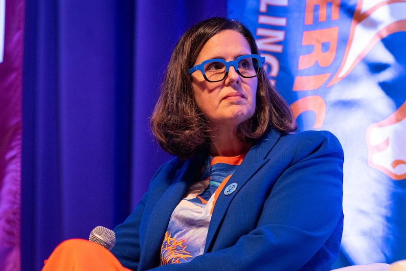 University of Texas at Arlington President Jennifer Cowley listens to another panelist speak...