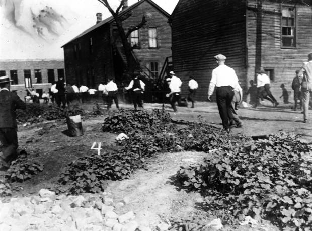 Young boys run to the corner where a young Black...