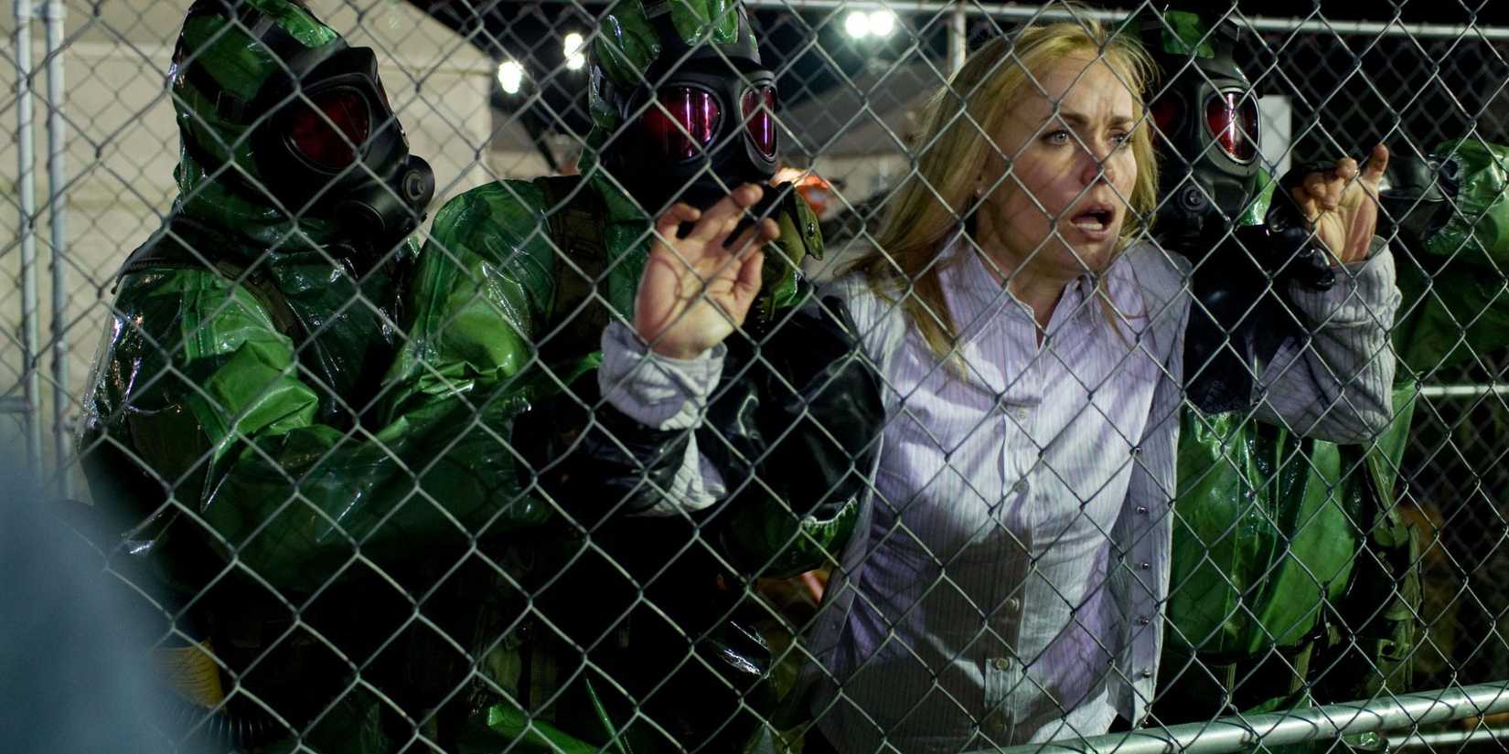 Men in hazmat suits search a woman in The Crazies 2010 