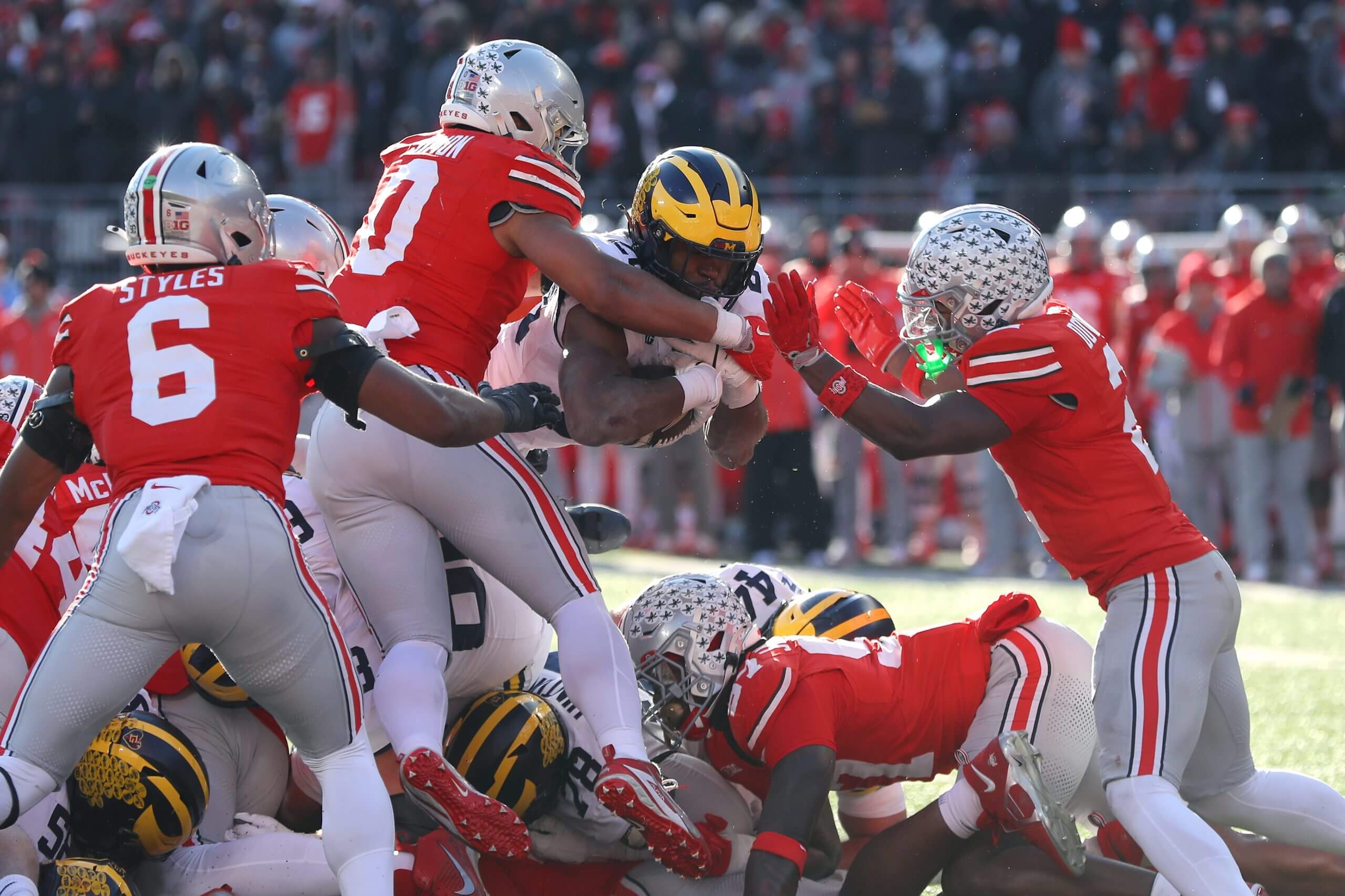 Michigan Wolverines running back Kalel Mullings dives through Ohio State defenders during last year's rivalry game in Columbus