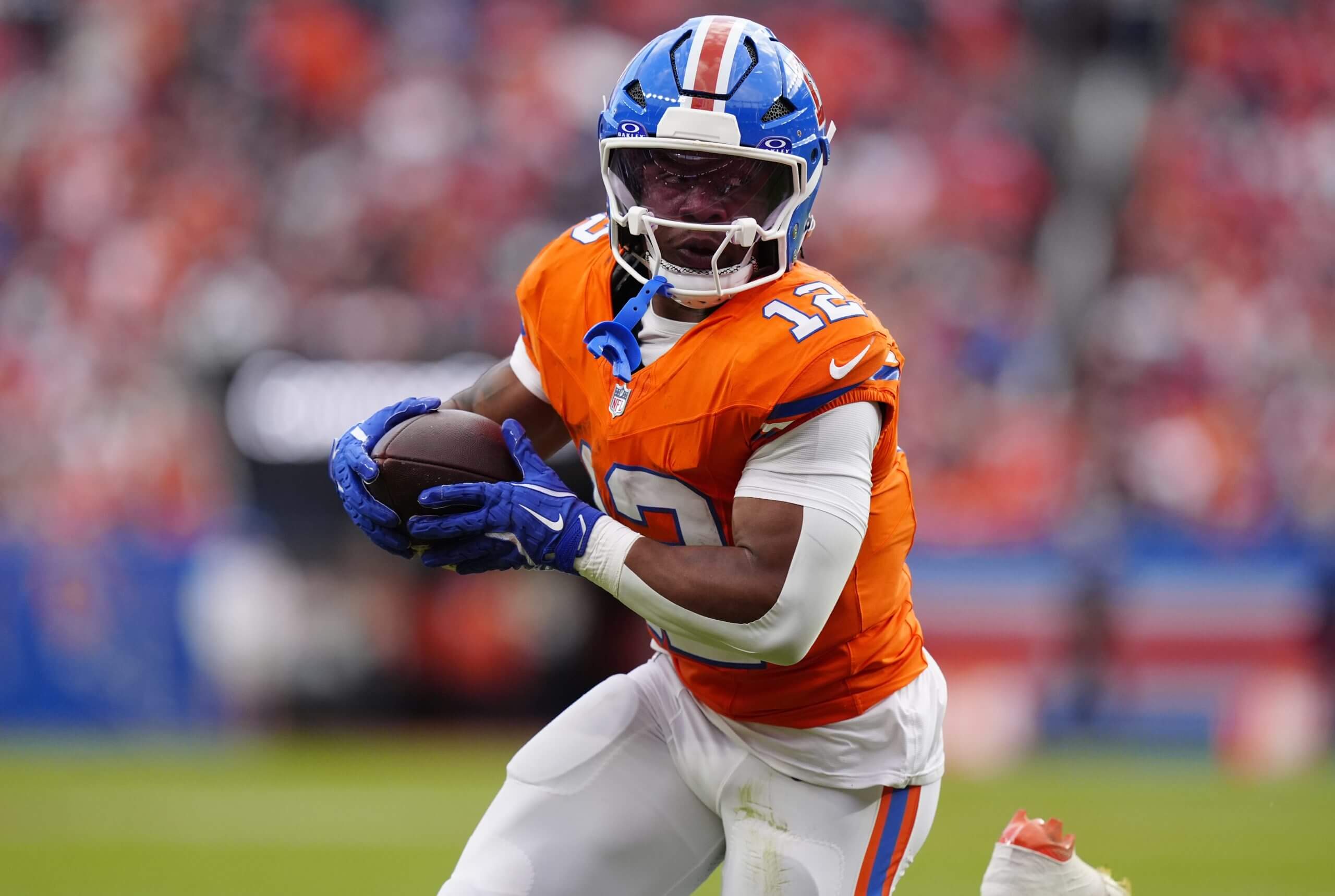 Denver Broncos running back RJ Harvey (12) runs against the Dallas Cowboys in the second half at Empower Field at Mile High.