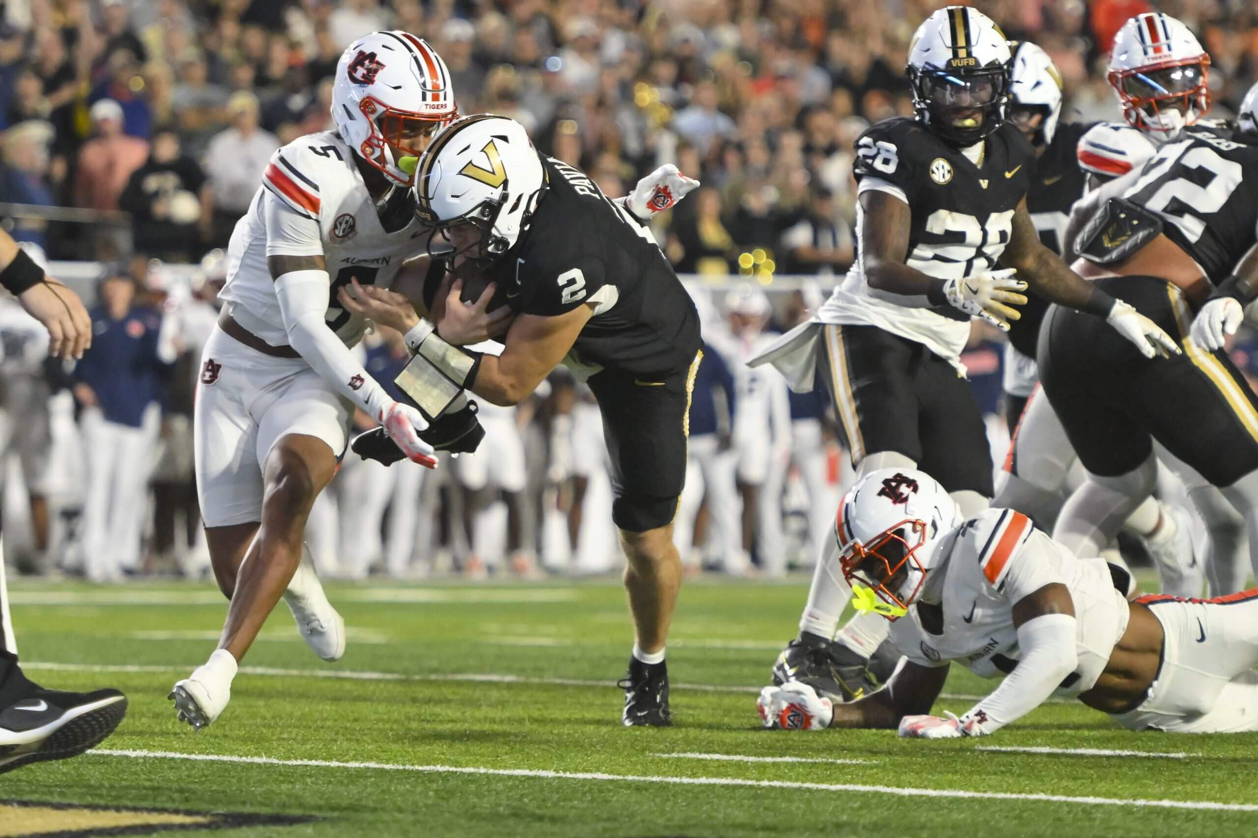 Diego Pavia dives for the endzone as an Auburn tackler closes in.