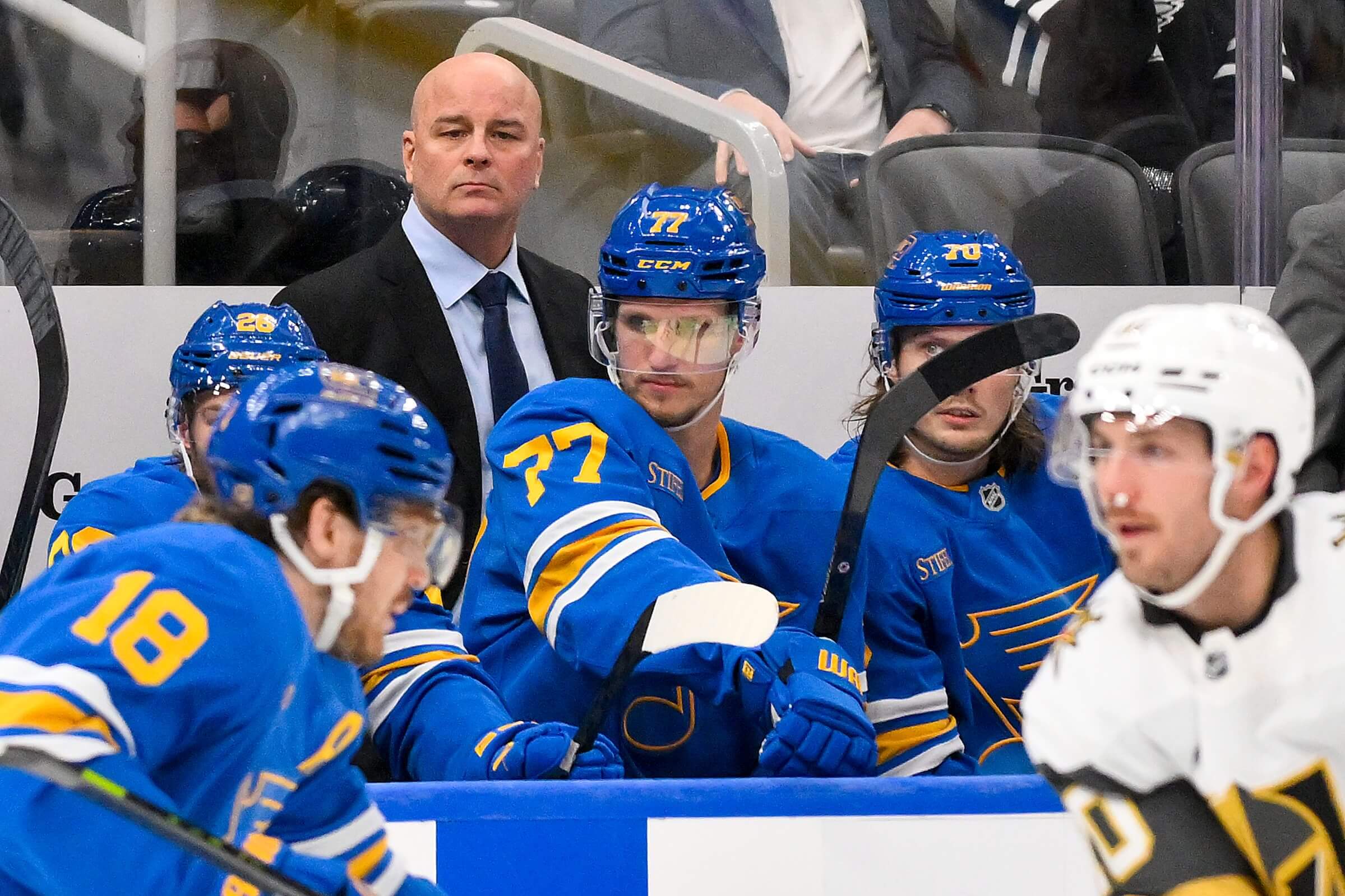 Blues coach Jim Montgomery looks on from behind the bench.