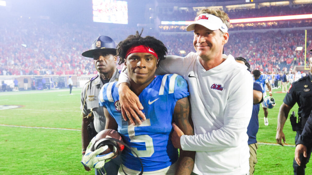 Mississippi Rebels head coach Lane Kiffin embraces running back Kewan Lacy (5) after defeating the Florida Gators at Vaught-Hemingway Stadium. (Petre Thomas-Imagn Images)