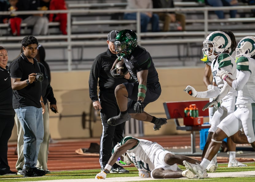 Propser High School running back Bryce Robinson (6) leaps over tacklers from Richardson...
