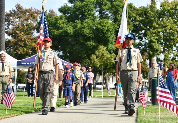 Local scouts process with the flags as the City of...