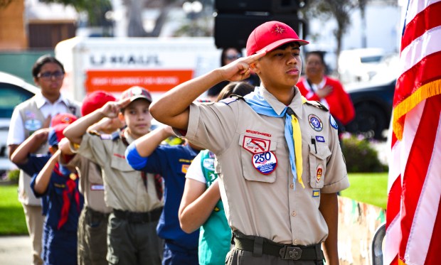 Local scouts salute during the National Anthem as the City...