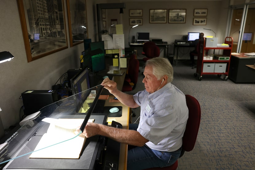 Bruce Seibold scans pages as he researches about family history at the heritage lab, on...