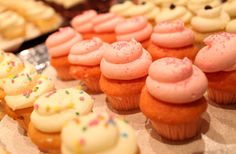 In this 2011 file photo, Society Bakery's owner displays cupcakes piped high with frosting....