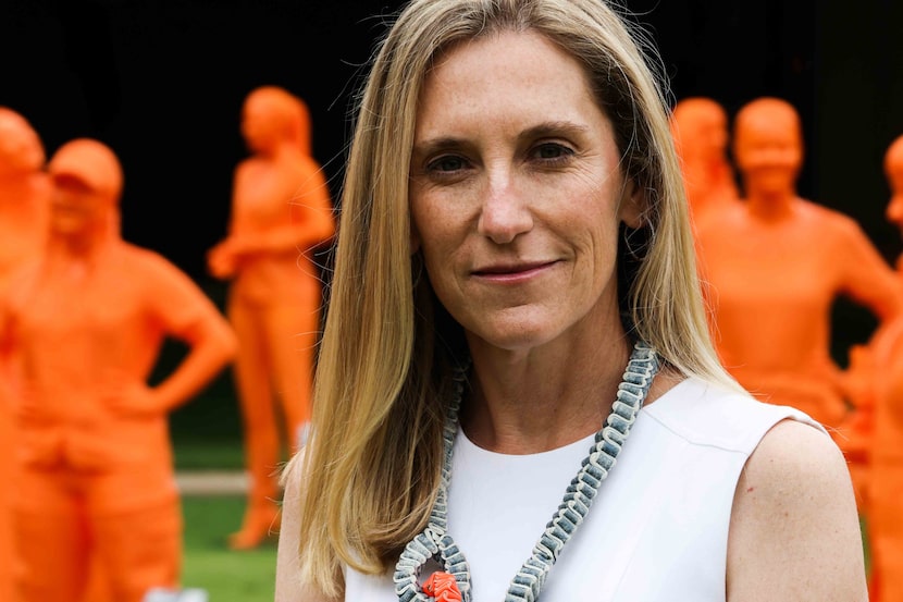 Nicole Small, CEO of LH Capital Inc., surrounded by more than 100 sculptures, all of women...