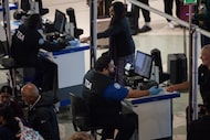 TSA workers check in passengers at the security checkpoint at Dallas Love Field on Friday,...
