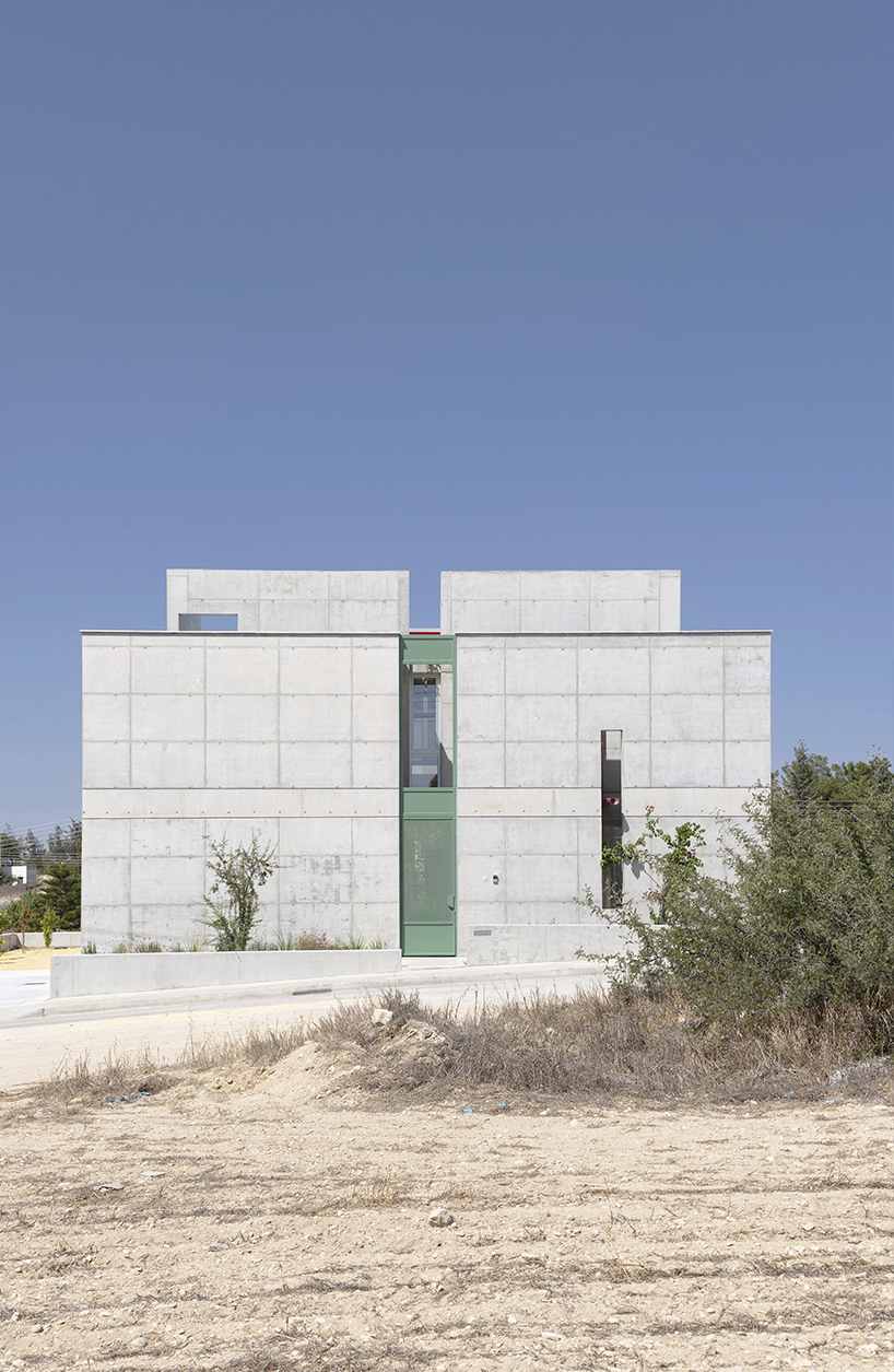 vertical cuts split monolithic 'cube within a cube' suburban residence in cyprus