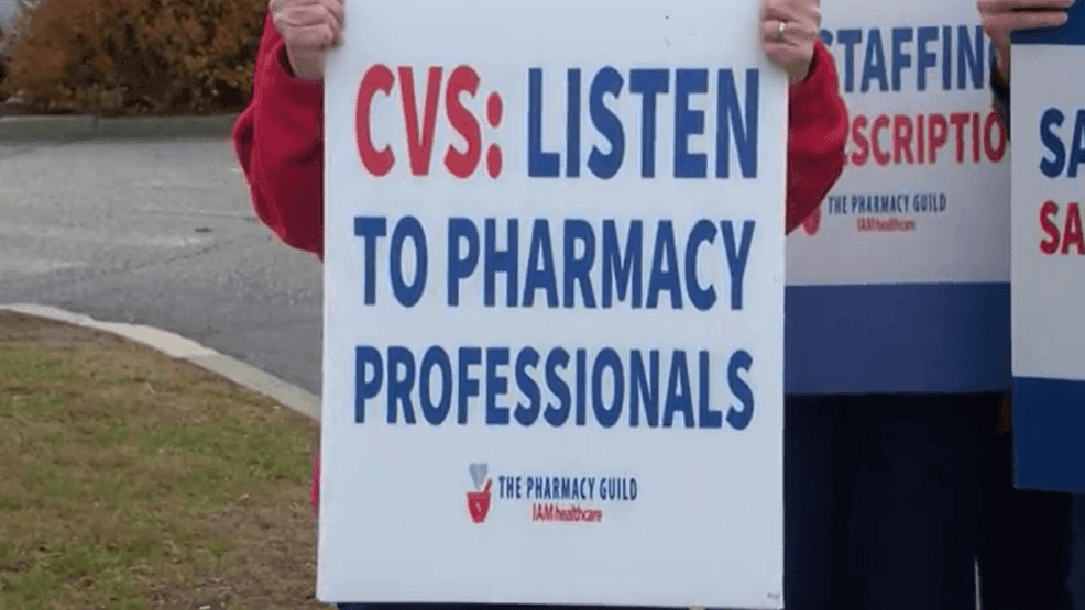 A sign being held by a union worker outside of CVS. (WJAR)