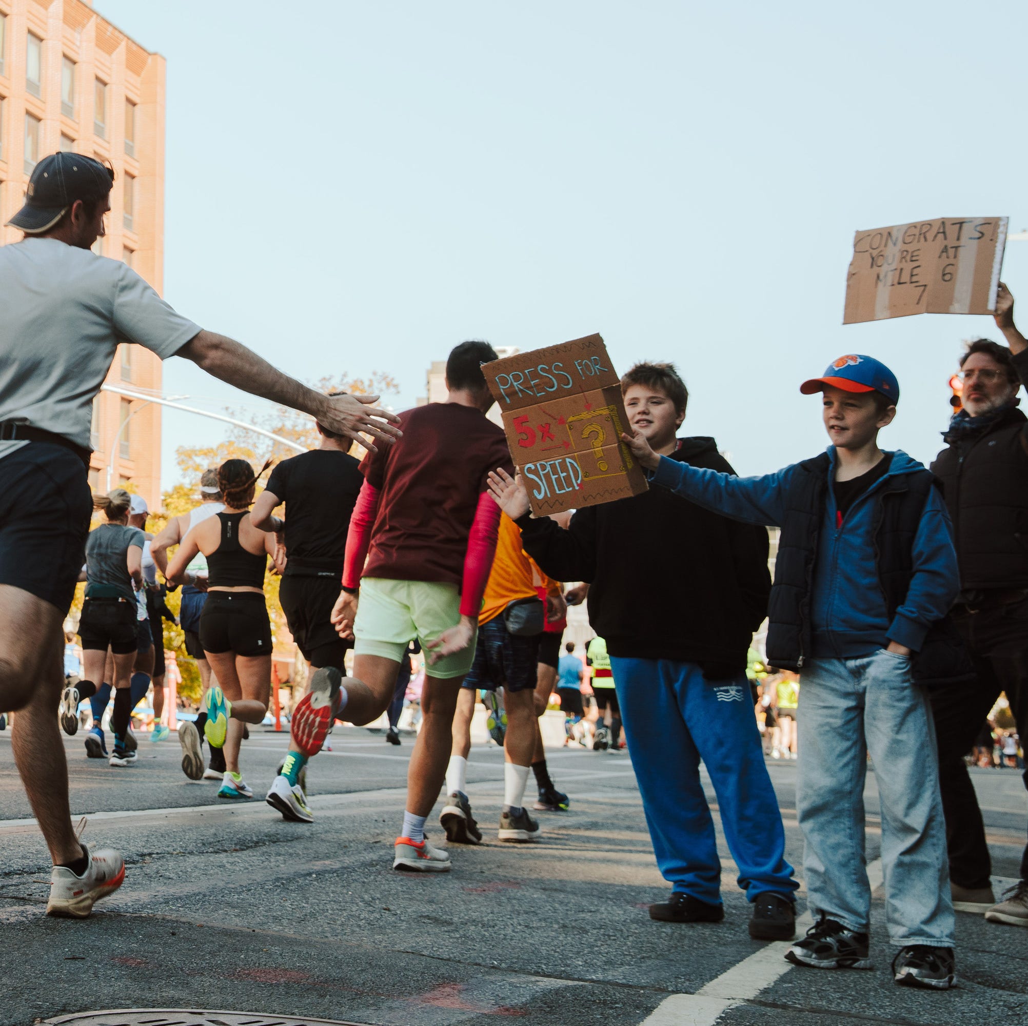 runners in a marathon on city streets runners in a marathon on city streets