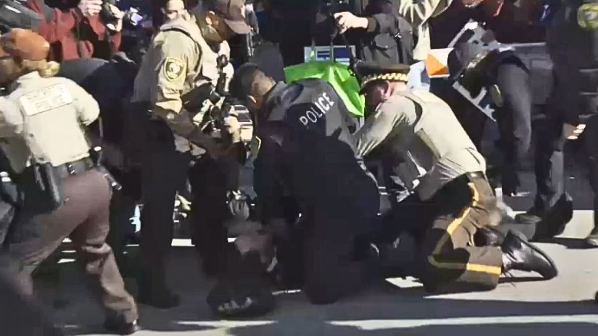 Police officers arrest a protester during an anti-ICE demonstration in Chicago.