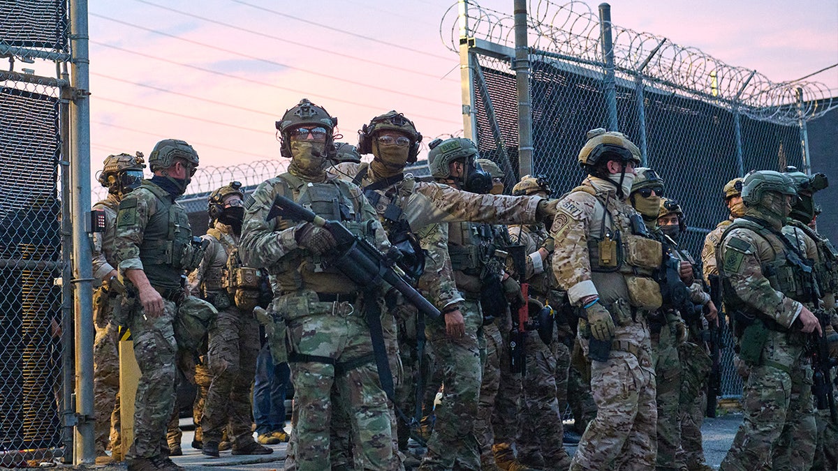 Federal agents confront protesters outside the ICE Detention Center
