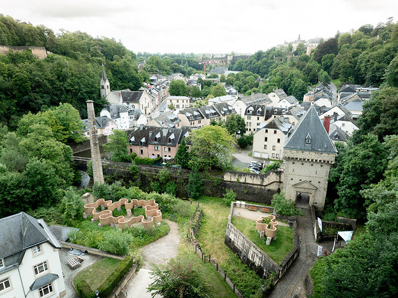 atelier faber stacks reeds over luxembourg sandstone to revive soil porosity on old well site