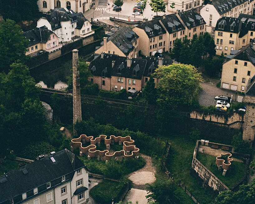 atelier faber stacks reeds over luxembourg sandstone to revive soil porosity on old well site