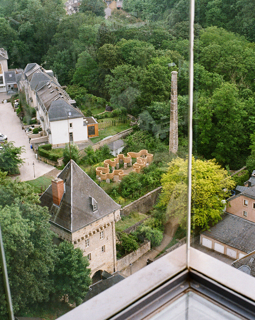 atelier faber stacks reeds over luxembourg sandstone to revive soil porosity on old well site