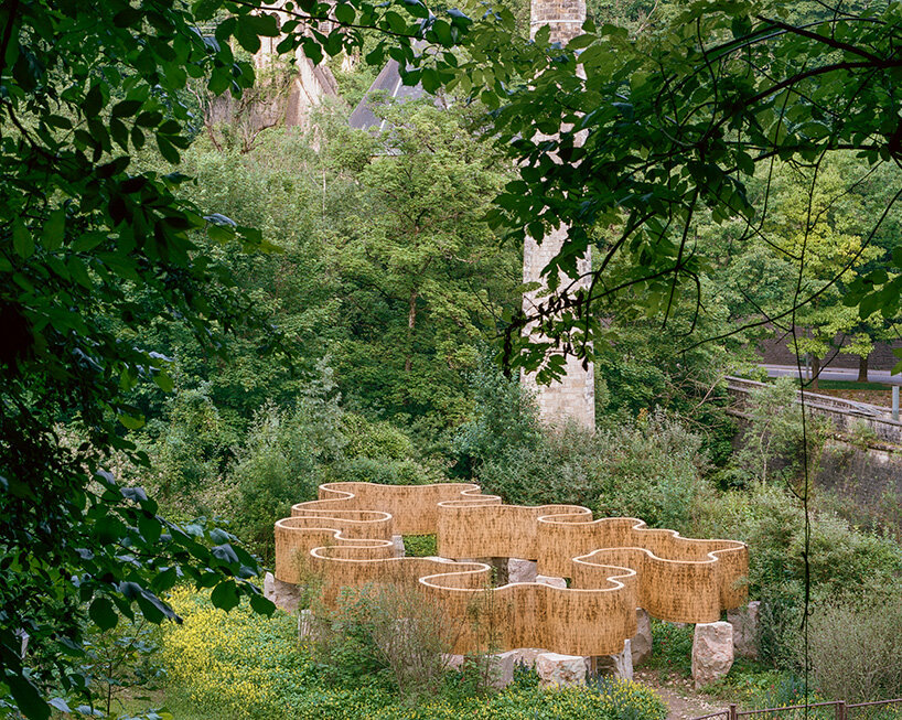 atelier faber stacks reeds over luxembourg sandstone to revive soil porosity on old well site
