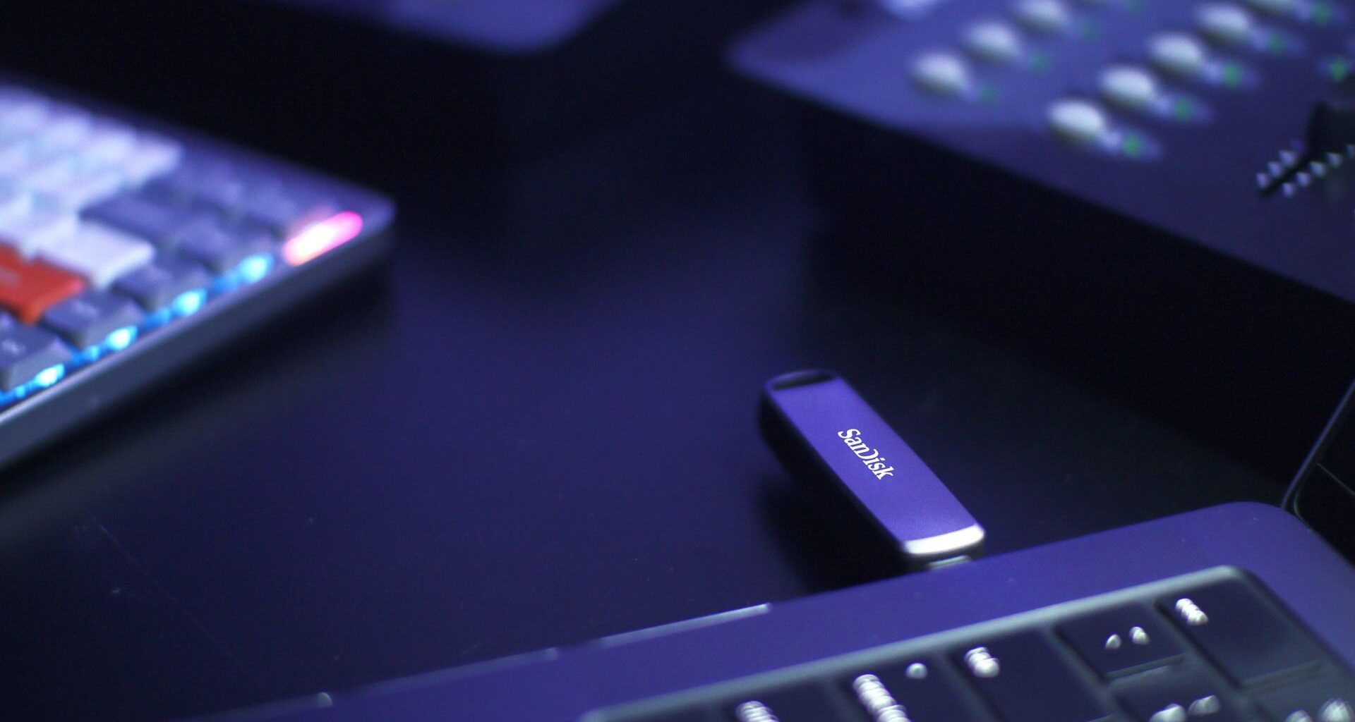 A promotional photograph of a Sandisk USB flash drive protruding from a laptop.