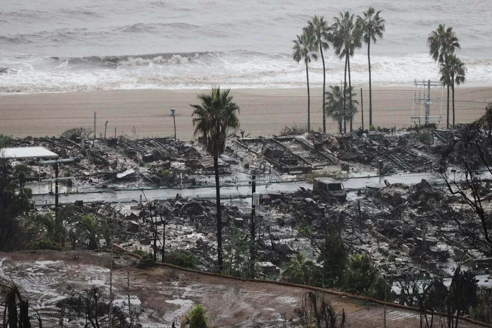 Rain comes down on a neighborhood in the Palisades Fire zone in the Pacific Palisades section of Los Angeles. (AP Photo/Ethan Swope)