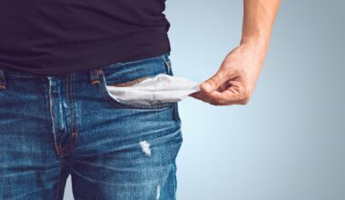 Man turning out empty pocket. Low income is a problem.