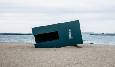buried souvenir shop on japanese shoreline reflects on tourism, land, and memory
