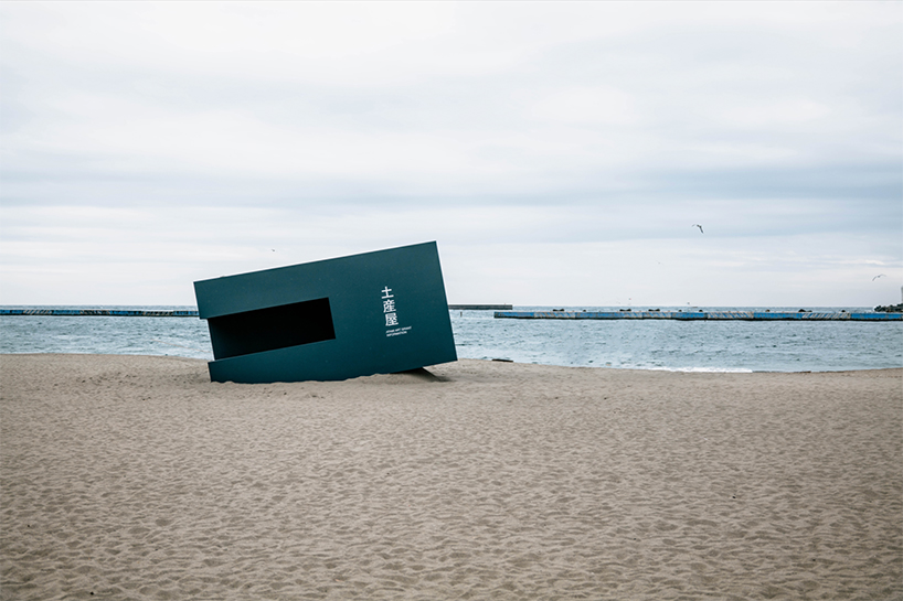buried souvenir shop on japanese shoreline reflects on tourism, land, and memory