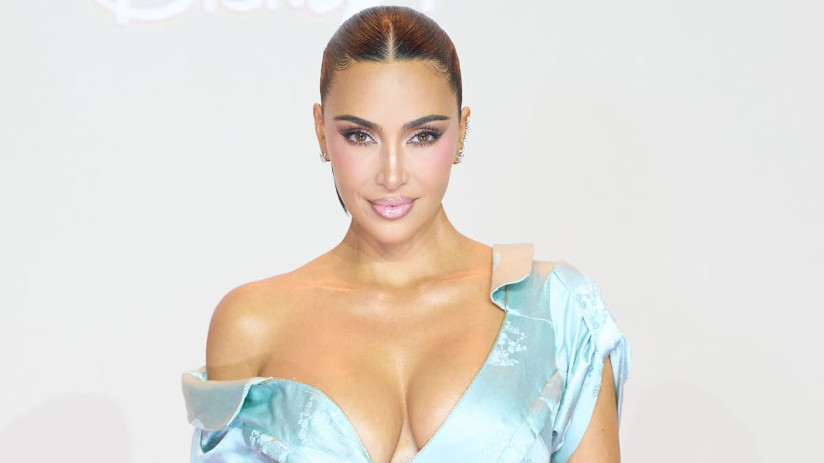 Kim Kardashian poses in blue gown