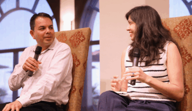 Rios interviews a woman at the Kroc Theatre at USD