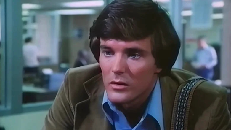Nicholas Hammond as Peter Parker is seen in closeup sitting in a newsroom in The Amazing Spider-Man