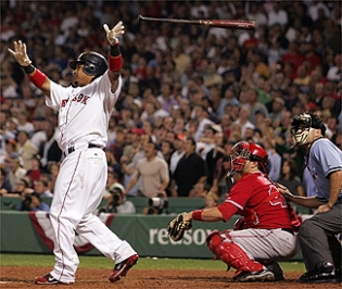 There she goes: Manny Ramirez lets the bat go and watches his walkoff, three-run home run in the ninth inning last night along with Angels catcher Mike Napoli and umpire Dan Iassongna.