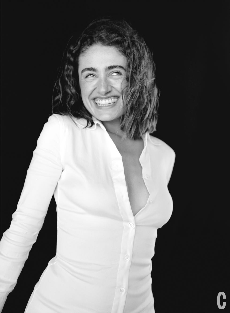 rachel sennott posing in a white button down