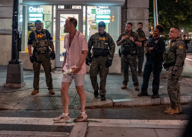 FBI and Border Patrol officers speak with Sean Charles Dunn after he allegedly assaulted law enforcement with a sandwich on Aug. 10, 2025, in Washington. (Andrew Leyden/Getty).