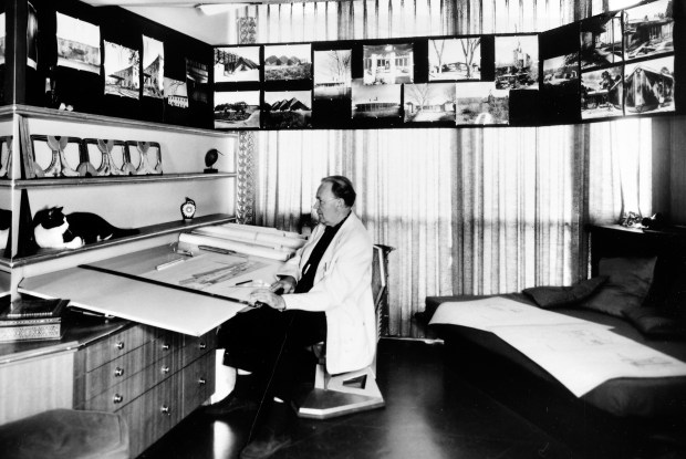 A 1962 photograph shows architect Bruce Goff in his studio with his cat, Chiaroscuro. Goff was daringly inventive and often used unconventional materials in designs. (Art Institute of Chicago)