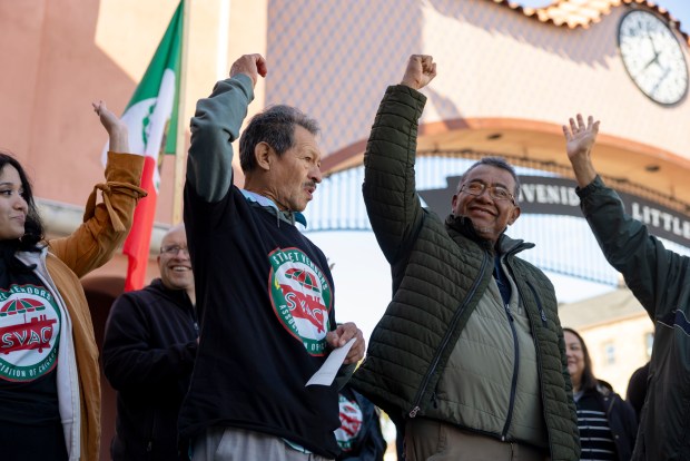 Salvador Salas, center, 75, who sells elotes from a cart, accepts a $500 check Sunday, Nov. 2, 2025, in the Little Village neighborhood from the Street Vendors Association of Chicago collected from donations to help during a time of decreased sales due to immigration enforcement. (Brian Cassella/Chicago Tribune)