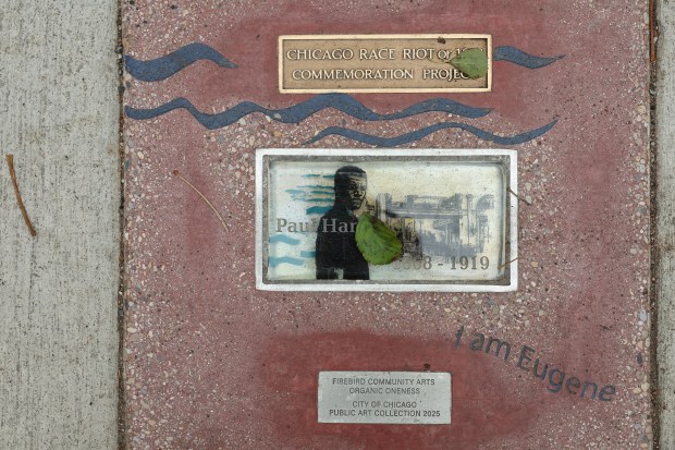 A ground marker with the name of Paul Hardwick etched in a glass brick is at the intersection of South Wabash Avenue and West Adams Street as part of the Chicago Race Riot of 1919 Commemoration Project, Nov. 8, 2025, in Chicago. Hardwick was one of 38 people killed during the riot. (John J. Kim/Chicago Tribune)