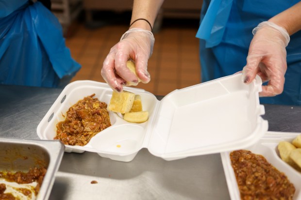 Volunteer Kathleen Stiles helps pack meals for Fight2Feed in the...