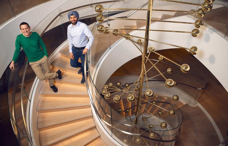 Jumper and Kohli standing on a double-helix staircase.