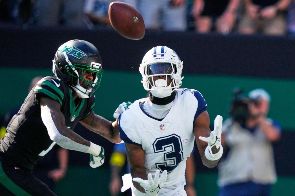 Dallas Cowboys' George Pickens catches a touchdown pass in front of New York Jets' Sauce Gardner during the second half of an NFL football game Sunday, Oct. 5, 2025, in East Rutherford, N.J.